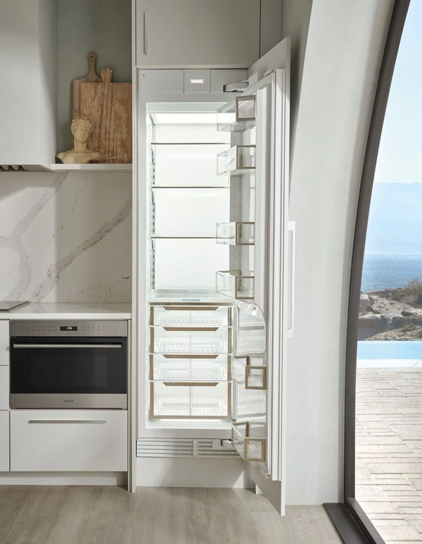 Built-in fridge with open door next to window